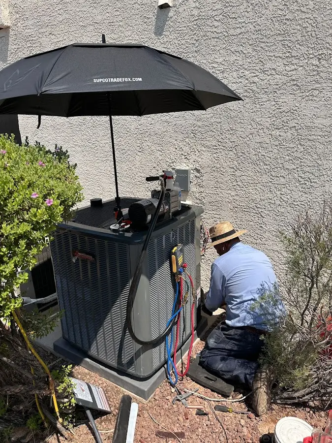 HVAC technician performing outdoor AC maintenance in Southold